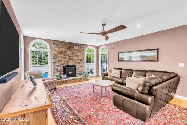 Fireplace, Interior, Living room, Recessed Lighting, Stone Walls, Wood Texture Flooring
