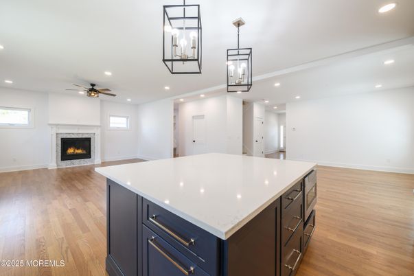 Empty room, Fireplace, Interior, Kitchen, Pendant Lights, Recessed Lighting, Wood Texture Flooring
