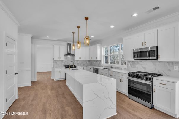 Interior, Kitchen, Marble Walls, Pendant Lights, Recessed Lighting, Stainless Steel Appliances, Wood Texture Flooring
