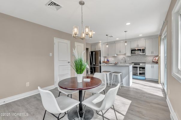 Dining room, Interior, Kitchen, Pendant Lights, Recessed Lighting, Stainless Steel Appliances, Wood Texture Flooring
