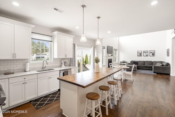 Fireplace, Interior, Kitchen, Living room, Pendant Lights, Recessed Lighting, Stainless Steel Appliances, Wood Texture Flooring