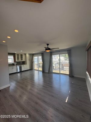 Empty room, Interior, Kitchen, Recessed Lighting, Stainless Steel Appliances, Wood Texture Flooring
