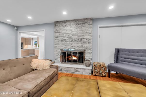 Fireplace, Interior, Living room, Recessed Lighting, Stone Walls, Wood Texture Flooring