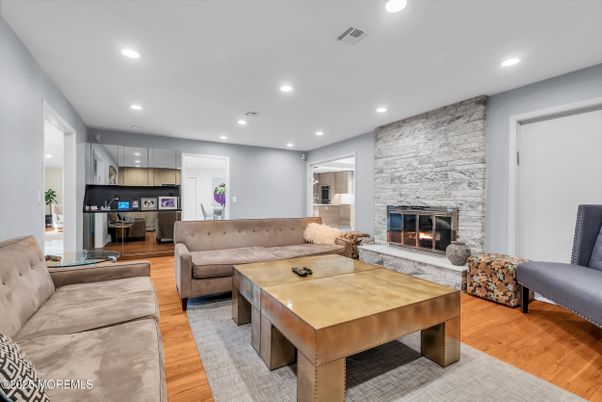 Fireplace, Interior, Living room, Recessed Lighting, Stone Walls, Wood Texture Flooring