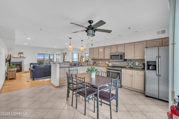 Dining room, Fireplace, Interior, Kitchen, Living room, Pendant Lights, Recessed Lighting, Stainless Steel Appliances, Wood Texture Flooring