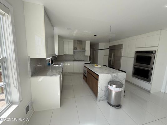 Interior, Kitchen, Marble Walls, Pendant Lights, Recessed Lighting, Stainless Steel Appliances