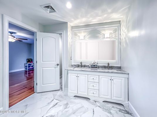 Bathroom, Dual Sink Vanities, Interior, Marble, Recessed Lighting, Wood Texture Flooring