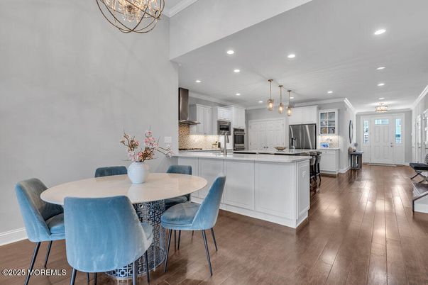 Chandelier, Dining room, Interior, Kitchen, Pendant Lights, Recessed Lighting, Stainless Steel Appliances, Wood Texture Flooring