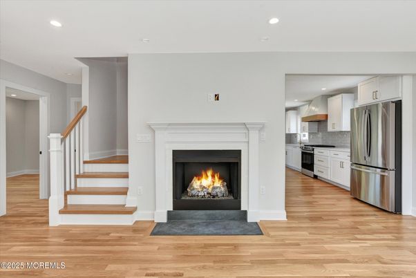Fireplace, Interior, Kitchen, Recessed Lighting, Stainless Steel Appliances, Wood Texture Flooring