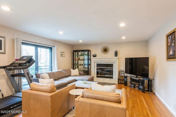 Fireplace, Fitness Equipment, Interior, Living room, Recessed Lighting, Wood Texture Flooring
