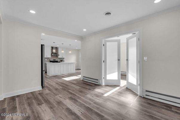 Empty room, Interior, Kitchen, Pendant Lights, Recessed Lighting, Stainless Steel Appliances, Wood Texture Flooring