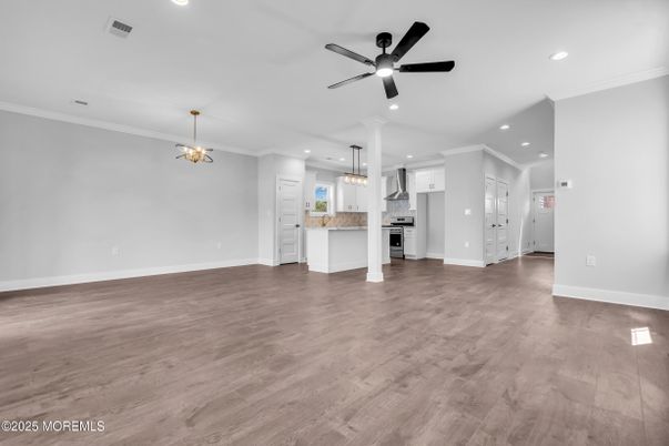 Chandelier, Empty room, Interior, Kitchen, Pendant Lights, Recessed Lighting, Stainless Steel Appliances, Wood Texture Flooring