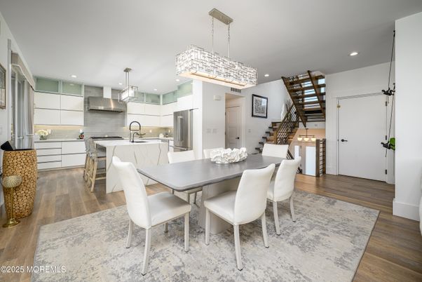 Chandelier, Dining room, Interior, Kitchen, Pendant Lights, Recessed Lighting, Stainless Steel Appliances, Wood Texture Flooring