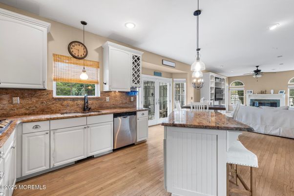 Dining room, Fireplace, Interior, Kitchen, Living room, Pendant Lights, Recessed Lighting, Stainless Steel Appliances, Wood Texture Flooring
