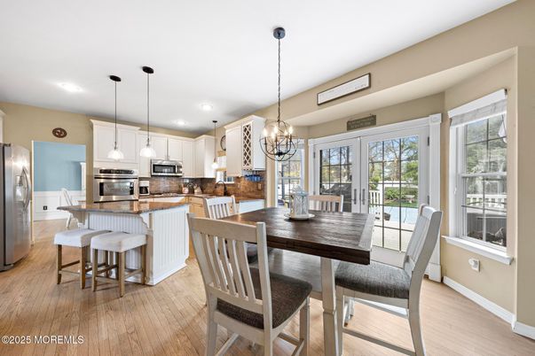 Chandelier, Dining room, Interior, Kitchen, Pendant Lights, Recessed Lighting, Stainless Steel Appliances, Wood Texture Flooring