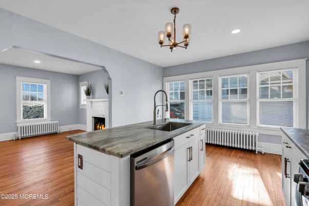 Chandelier, Fireplace, Interior, Kitchen, Recessed Lighting, Stainless Steel Appliances, Wood Texture Flooring