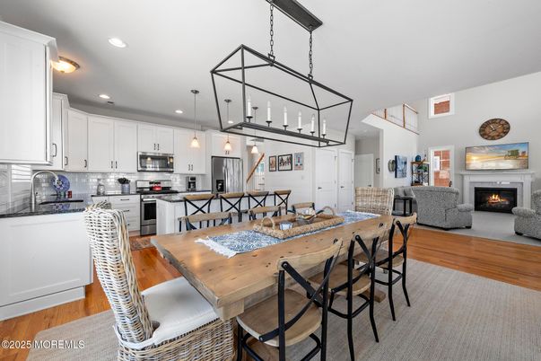 Dining room, Fireplace, Interior, Kitchen, Pendant Lights, Recessed Lighting, Stainless Steel Appliances, Wood Texture Flooring