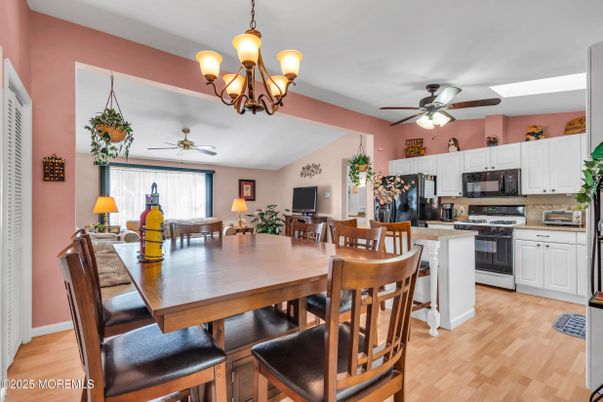 Chandelier, Dining room, Interior, Kitchen, Stainless Steel Appliances, Wood Texture Flooring