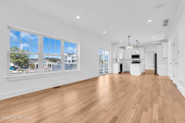 Empty room, Interior, Kitchen, Pendant Lights, Recessed Lighting, Stainless Steel Appliances, Wood Texture Flooring