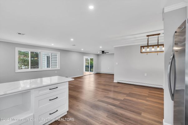 Empty room, Interior, Kitchen, Pendant Lights, Recessed Lighting, Stainless Steel Appliances, Wood Texture Flooring
