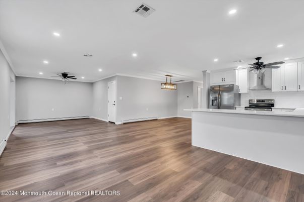 Empty room, Interior, Kitchen, Pendant Lights, Recessed Lighting, Stainless Steel Appliances, Wood Texture Flooring