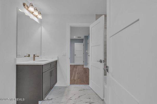Bathroom, Dual Sink Vanities, Interior, Marble, Recessed Lighting, Wood Texture Flooring