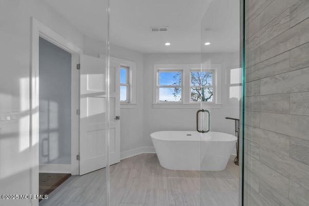 Bathroom, Free Standing Baths, Glass Shower, Interior, Recessed Lighting, Wood Texture Flooring