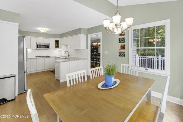 Chandelier, Dining room, Interior, Kitchen, Stainless Steel Appliances, Wood Texture Flooring
