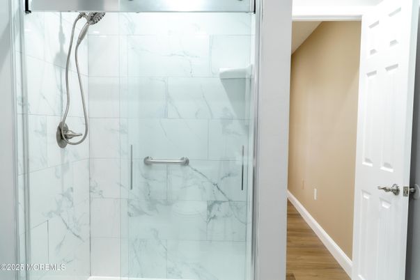 Bathroom, Glass Shower, Interior, Marble Walls, Wood Texture Flooring