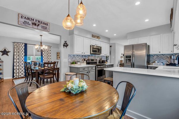 Chandelier, Dining room, Interior, Kitchen, Pendant Lights, Recessed Lighting, Stainless Steel Appliances, Wood Texture Flooring