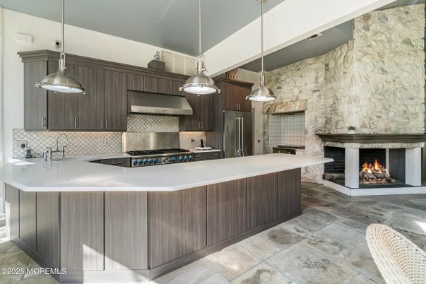 Fireplace, Interior, Kitchen, Pendant Lights, Stainless Steel Appliances, Stone Walls