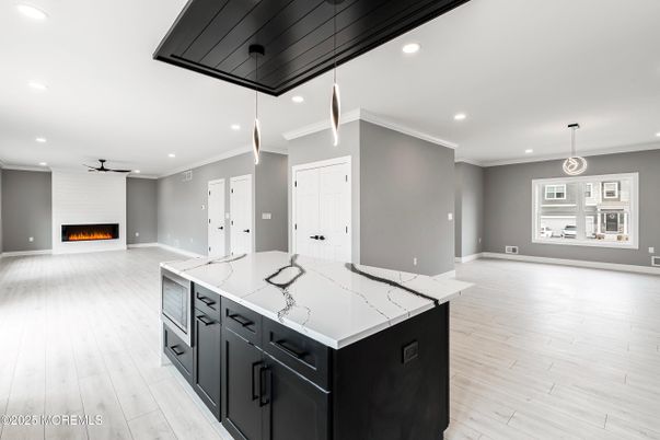Empty room, Fireplace, Interior, Kitchen, Pendant Lights, Recessed Lighting, Wood Texture Flooring