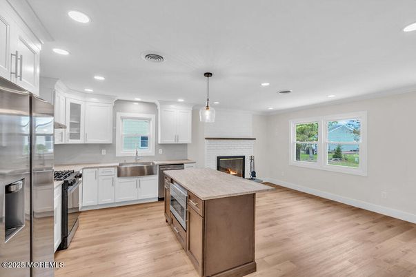 Fireplace, Interior, Kitchen, Pendant Lights, Recessed Lighting, Stainless Steel Appliances, Wood Texture Flooring
