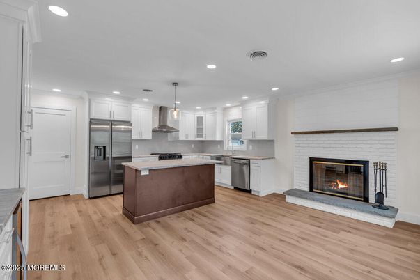 Fireplace, Interior, Kitchen, Pendant Lights, Recessed Lighting, Stainless Steel Appliances, Wood Texture Flooring