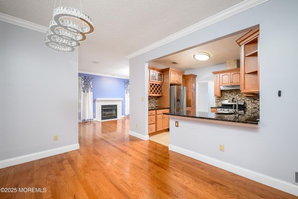 Fireplace, Interior, Kitchen, Stainless Steel Appliances, Wood Texture Flooring