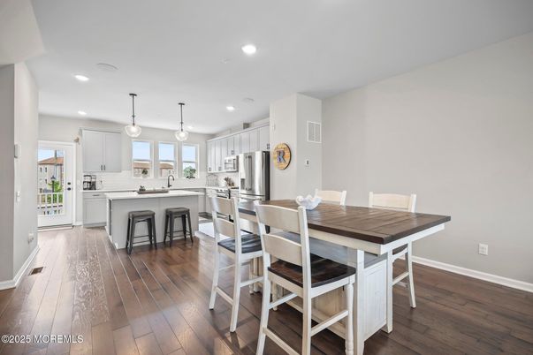 Dining room, Interior, Kitchen, Pendant Lights, Recessed Lighting, Stainless Steel Appliances, Wood Texture Flooring