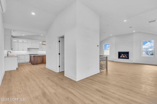 Empty room, Fireplace, Interior, Kitchen, Pendant Lights, Recessed Lighting, Wood Texture Flooring