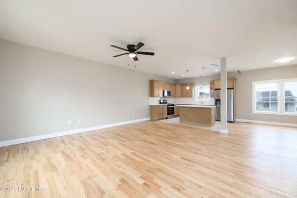 Empty room, Interior, Kitchen, Pendant Lights, Recessed Lighting, Stainless Steel Appliances, Wood Texture Flooring