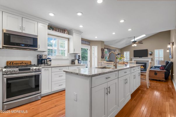 Fireplace, Interior, Kitchen, Living room, Recessed Lighting, Stainless Steel Appliances, Wood Texture Flooring