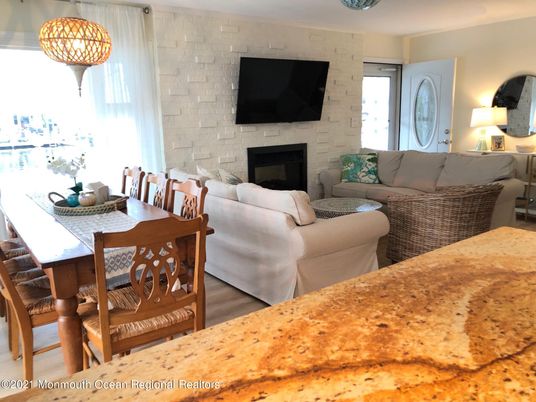 Dining room, Fireplace, Interior, Living room, Pendant Lights, Stone Walls, Wood Texture Flooring
