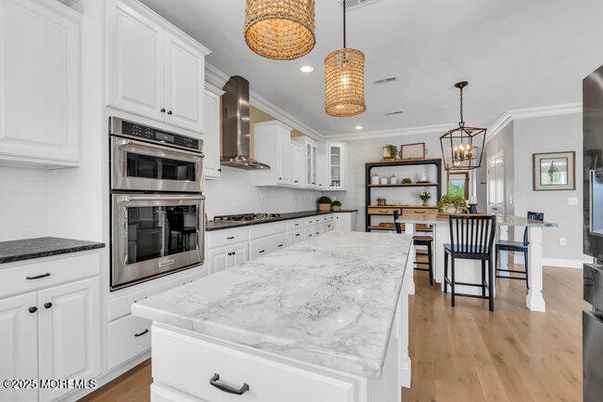 Chandelier, Dining room, Interior, Kitchen, Pendant Lights, Recessed Lighting, Stainless Steel Appliances, Wood Texture Flooring