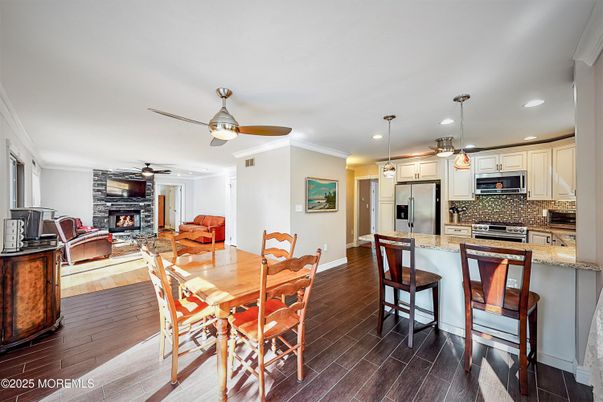 Dining room, Fireplace, Interior, Kitchen, Pendant Lights, Recessed Lighting, Stainless Steel Appliances, Wood Texture Flooring