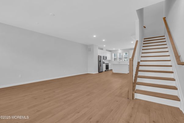 Empty room, Interior, Kitchen, Recessed Lighting, Stainless Steel Appliances, Wood Texture Flooring