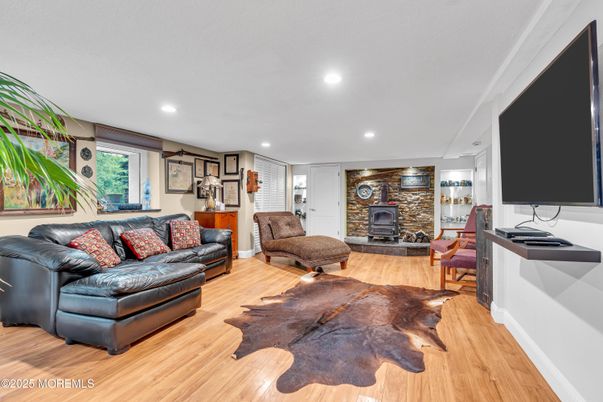 Fireplace, Interior, Living room, Recessed Lighting, Stone Walls, Wood Texture Flooring