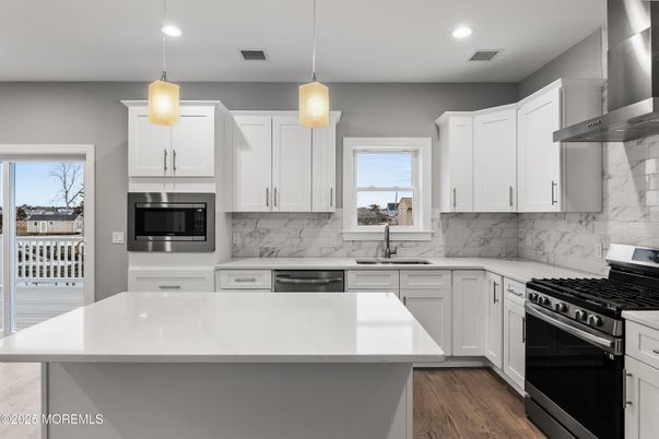 Interior, Kitchen, Marble Walls, Pendant Lights, Recessed Lighting, Stainless Steel Appliances, Wood Texture Flooring
