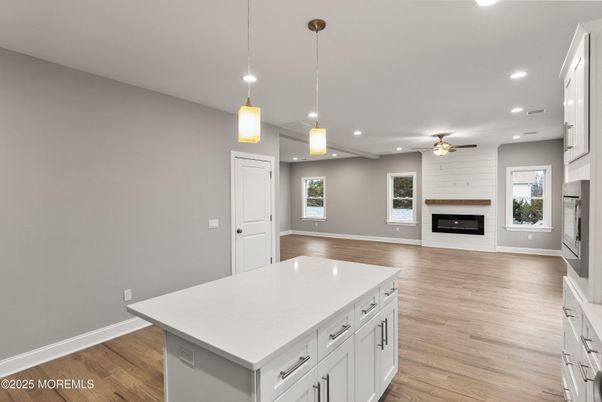 Empty room, Fireplace, Interior, Kitchen, Pendant Lights, Recessed Lighting, Wood Texture Flooring