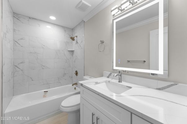 Bathroom, Dual Sink Vanities, Interior, Marble Walls, Recessed Lighting, Wood Texture Flooring