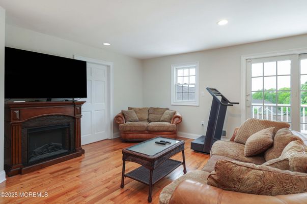 Fireplace, Fitness Equipment, Interior, Living room, Recessed Lighting, Wood Texture Flooring