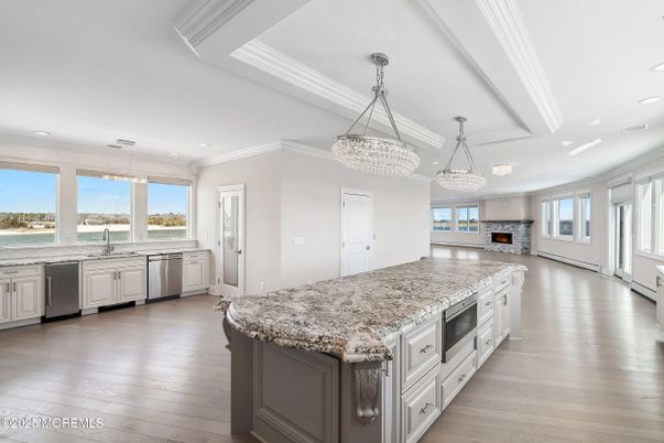 Chandelier, Fireplace, Interior, Kitchen, Pendant Lights, Recessed Lighting, Stainless Steel Appliances, Wood Texture Flooring