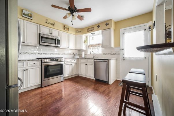 Interior, Kitchen, Stainless Steel Appliances, Tile Countertops, Wood Texture Flooring